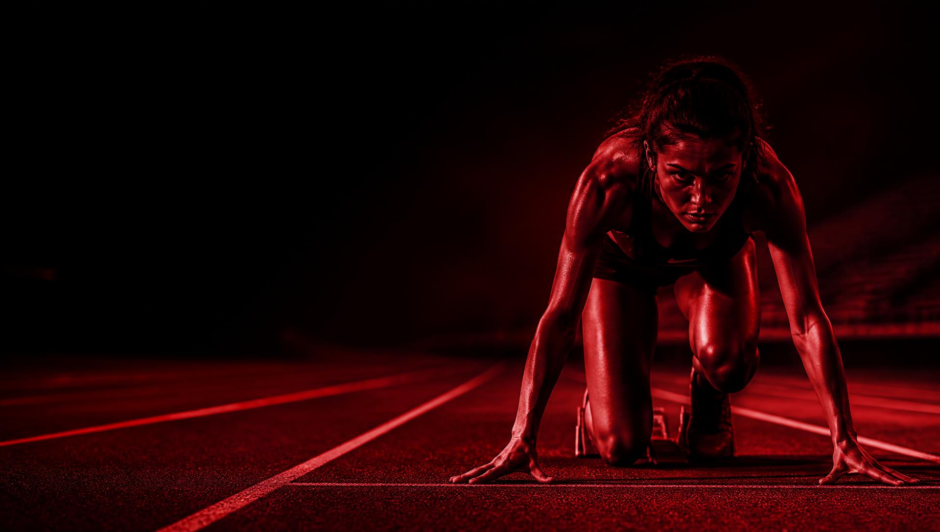 Sprinter in the starting blocks on a track